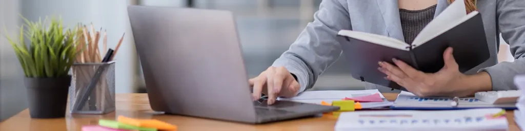 Image of a business woman manager accounting using computer and documents